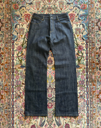 Jeans “Fusion Bootcut” in raw denim originale cimosato, ricamo e bottoni e rivetti in ottone logati