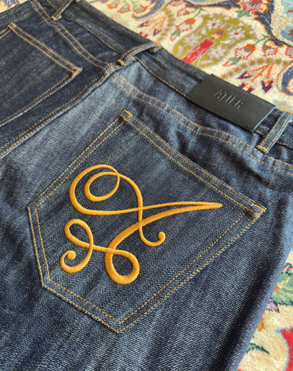 Jeans “Fusion Bootcut” in raw denim originale cimosato, ricamo e bottoni e rivetti in ottone logati
