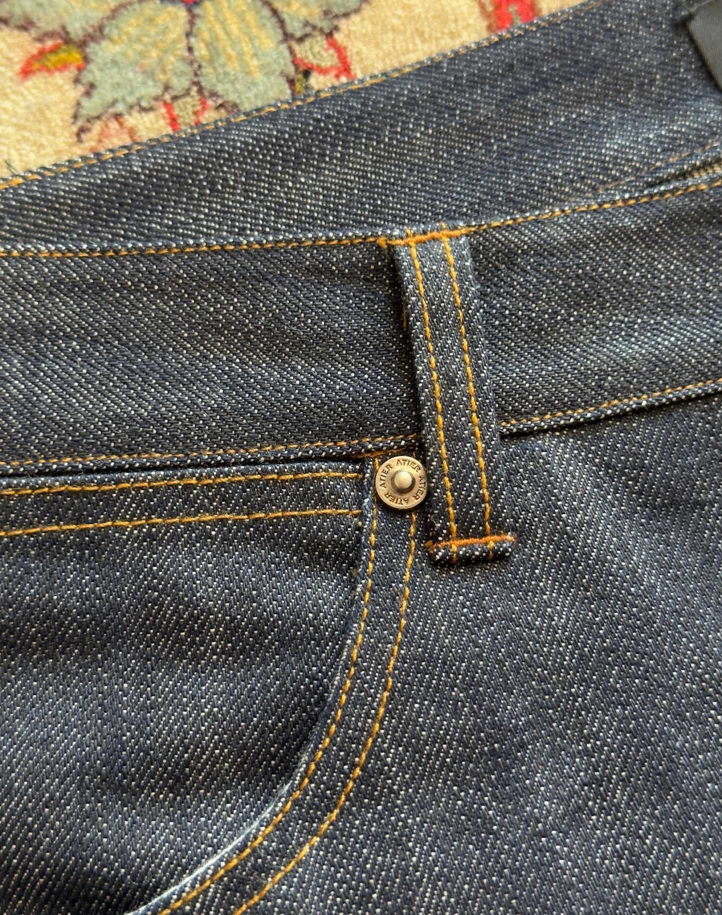 Jeans “Fusion Bootcut” in raw denim originale cimosato, ricamo e bottoni e rivetti in ottone logati