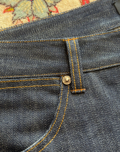 Jeans “Fusion Bootcut” in raw denim originale cimosato, ricamo e bottoni e rivetti in ottone logati