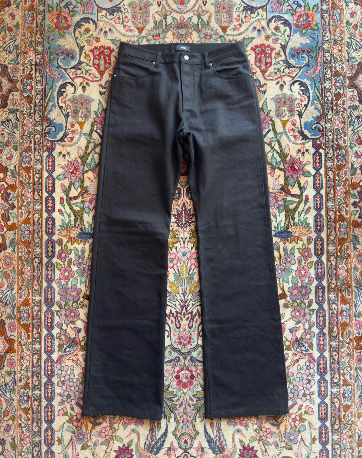 Jeans “Fusion Bootcut” in raw denim originale cimosato, ricamo e bottoni e rivetti in ottone logati