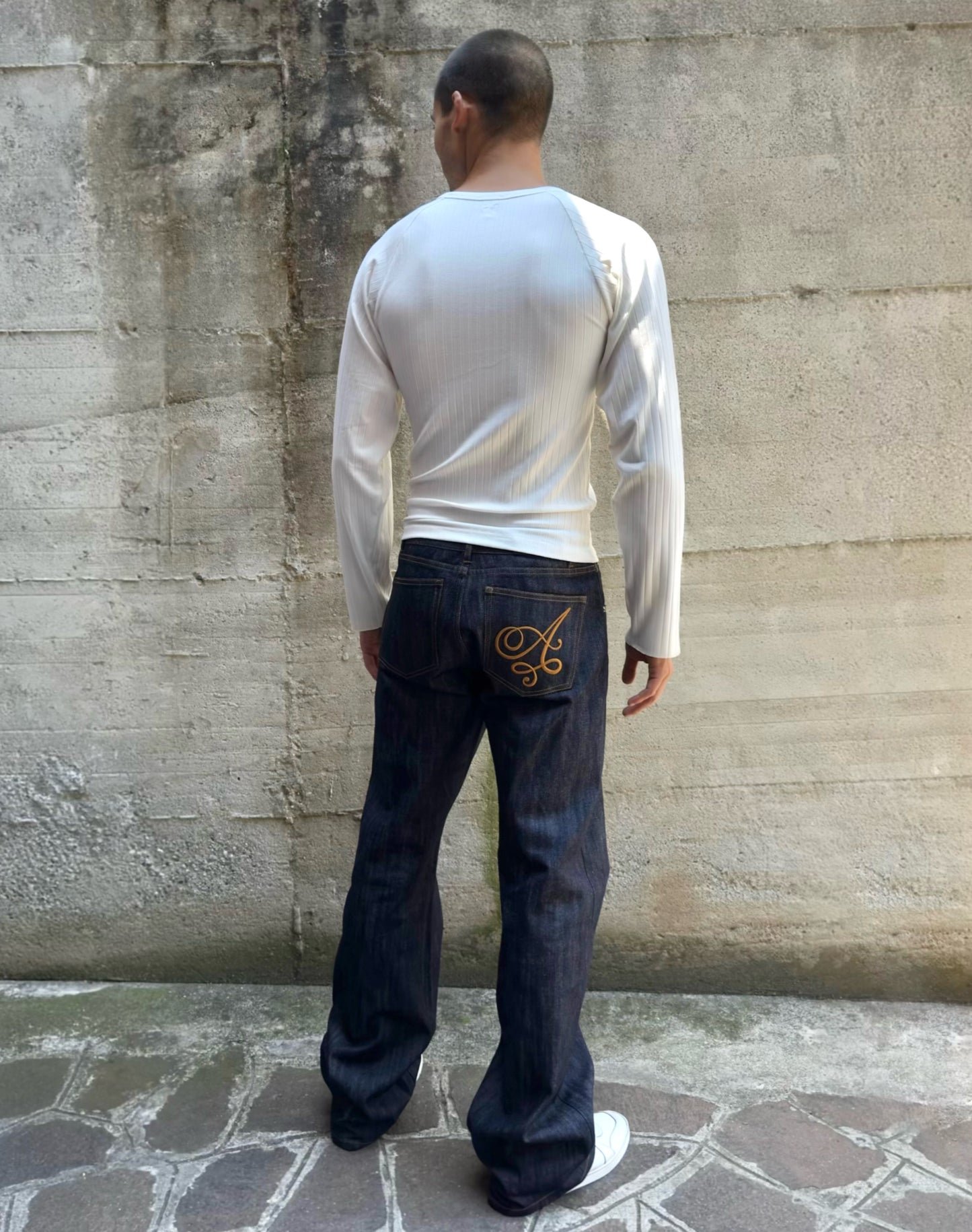 Jeans “Fusion Bootcut” in raw denim originale cimosato, ricamo e bottoni e rivetti in ottone logati
