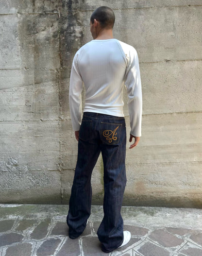 Jeans “Fusion Bootcut” in raw denim originale cimosato, ricamo e bottoni e rivetti in ottone logati