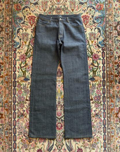 Jeans “Fusion Bootcut” in raw denim originale cimosato, ricamo e bottoni e rivetti in ottone logati