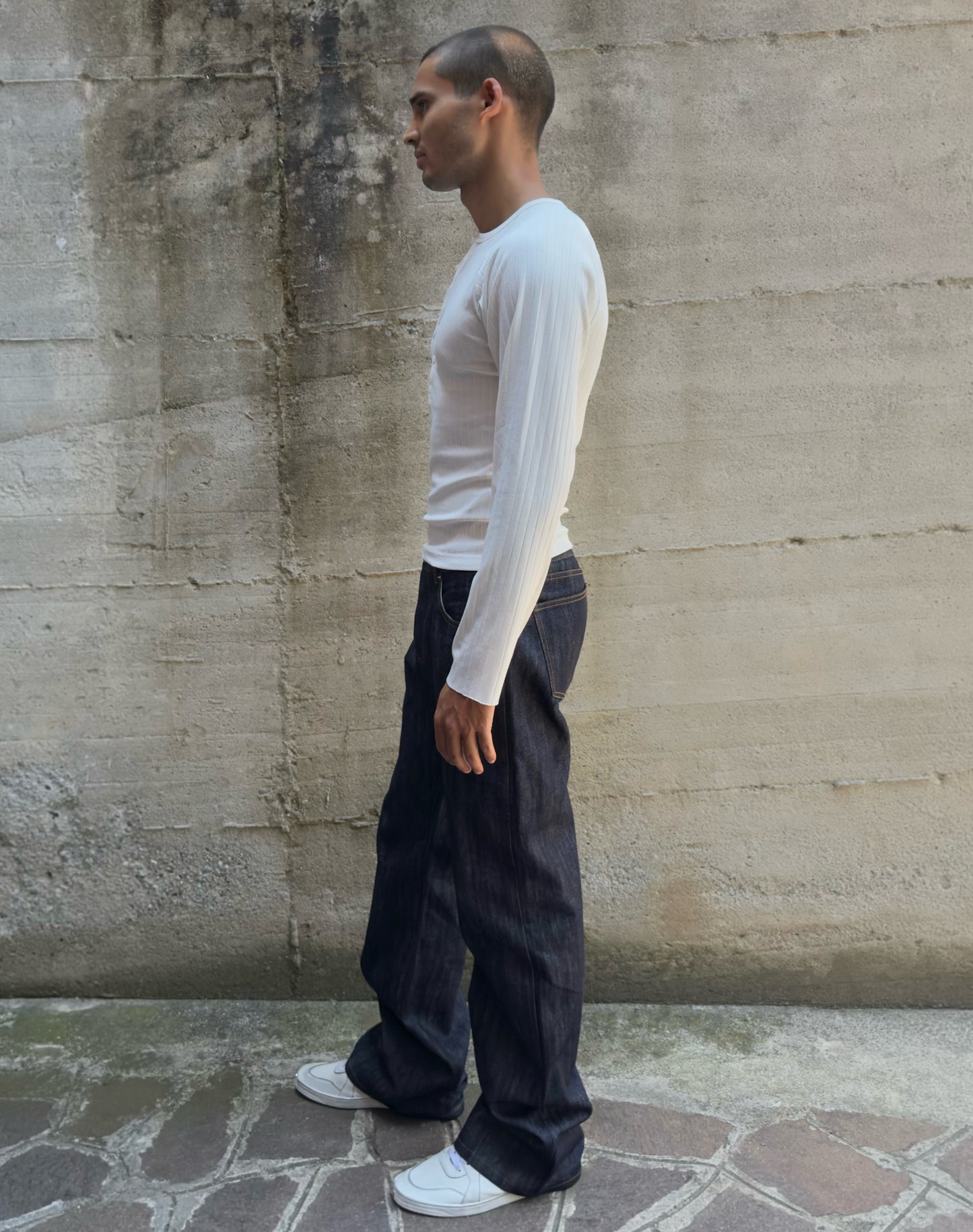 Jeans “Fusion Bootcut” in raw denim originale cimosato, ricamo e bottoni e rivetti in ottone logati