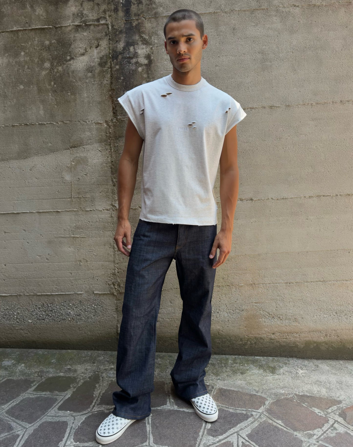 Jeans “Fusion Bootcut” in raw denim originale cimosato, ricamo e bottoni e rivetti in ottone logati