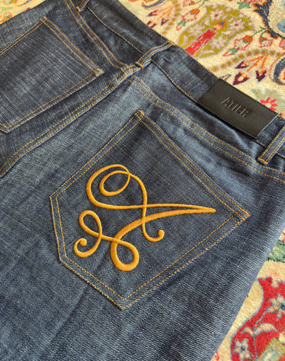 Jeans “Fusion Bootcut” in raw denim originale cimosato, ricamo e bottoni e rivetti in ottone logati