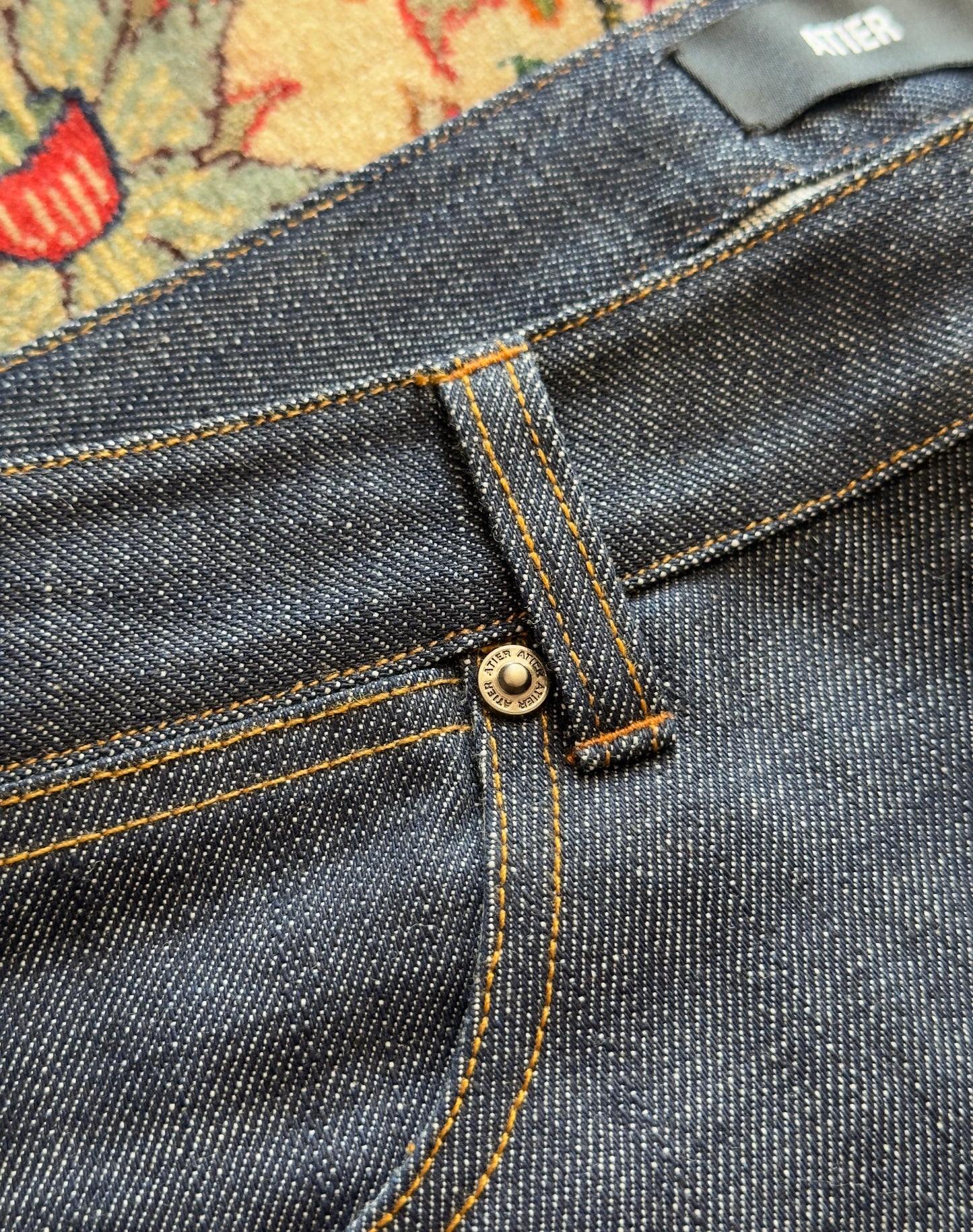 Jeans “Fusion Bootcut” in raw denim originale cimosato, ricamo e bottoni e rivetti in ottone logati