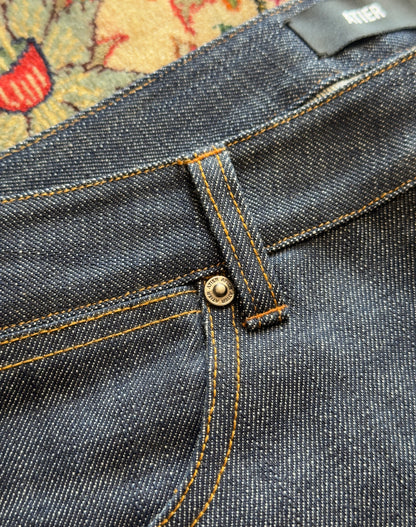 Jeans “Fusion Bootcut” in raw denim originale cimosato, ricamo e bottoni e rivetti in ottone logati